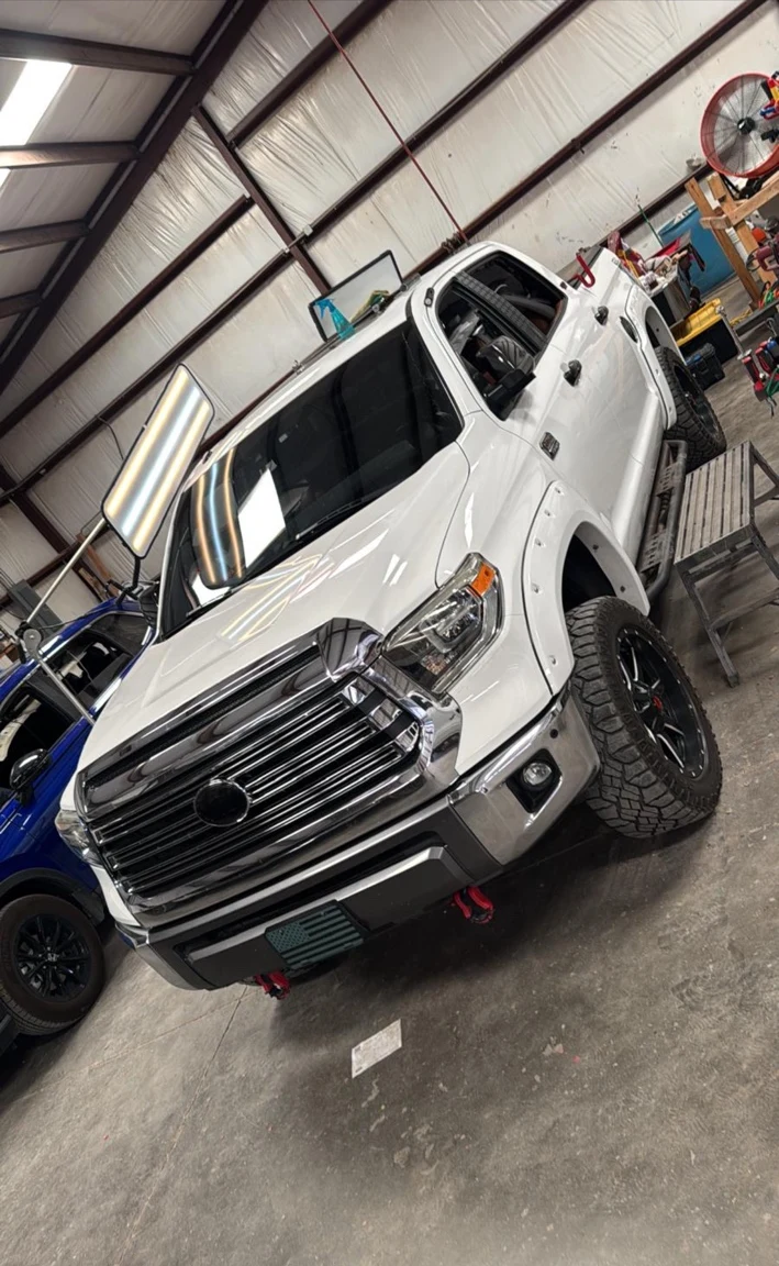 White truck inside the iFix Auto Hail repair shop