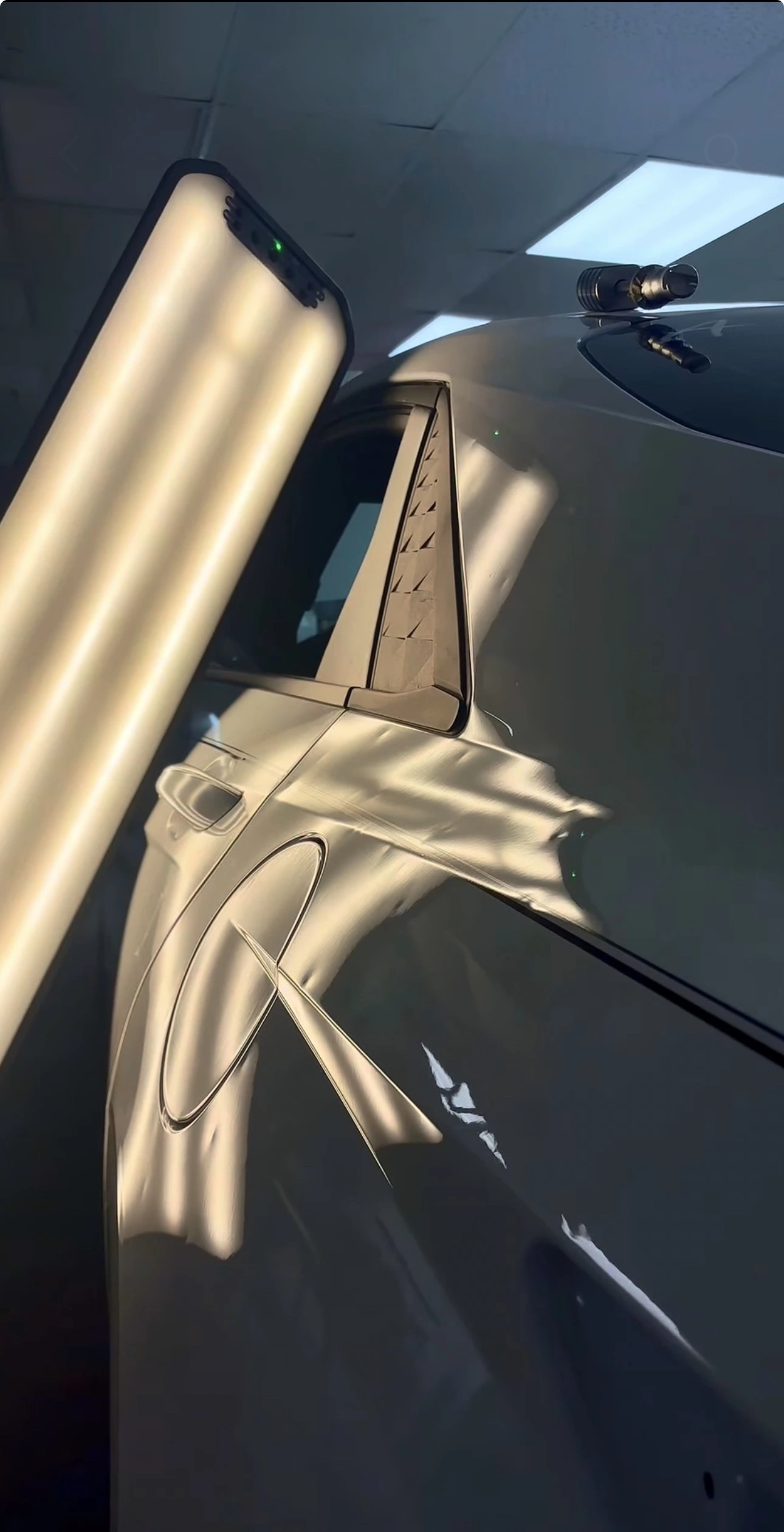 Hands-on paintless dent repair with professional lighting and tools